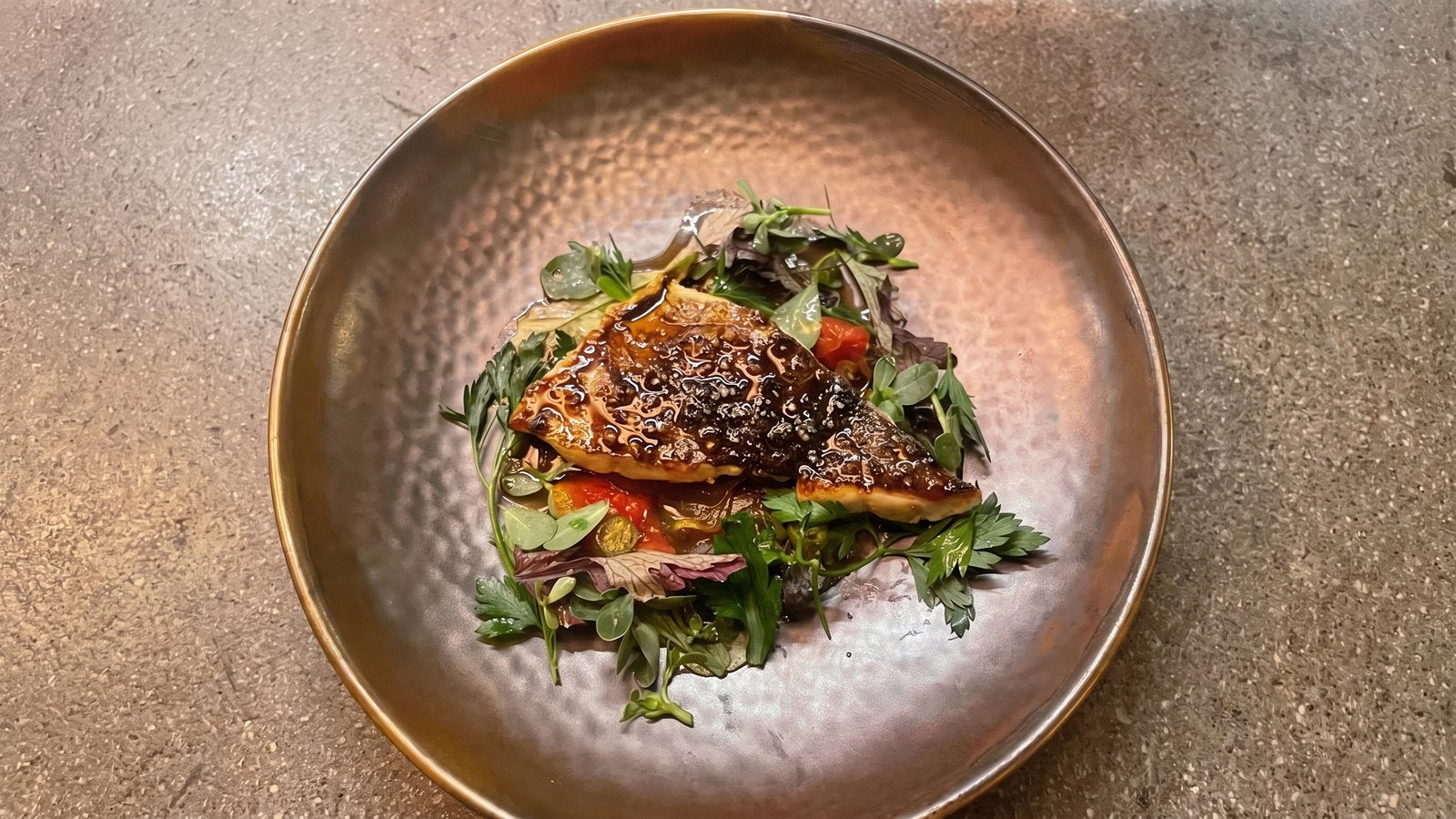Glazed fish on a gold hammered plate